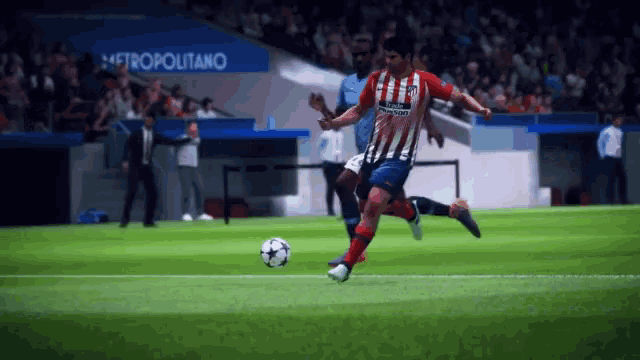 a soccer player in a red white and blue uniform kicks the ball