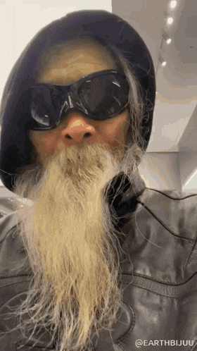 a man with a long beard wearing sunglasses and a hat