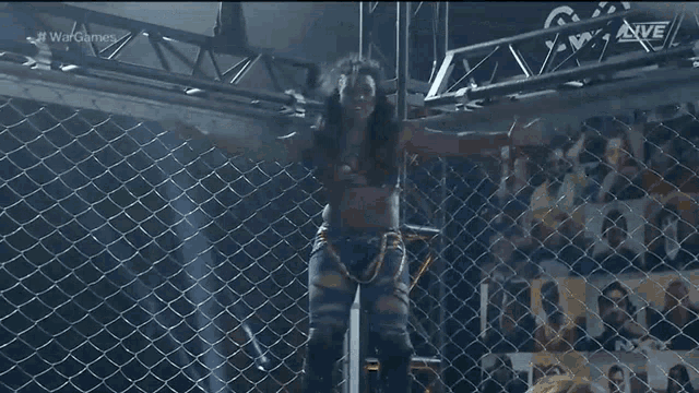 a wrestling match is being broadcast live on a television screen .