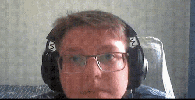 a boy wearing glasses and headphones with the letter m on the ear