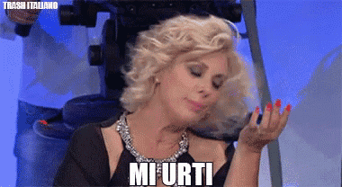 a woman in a black dress is making a funny face and the words mi urti are above her head
