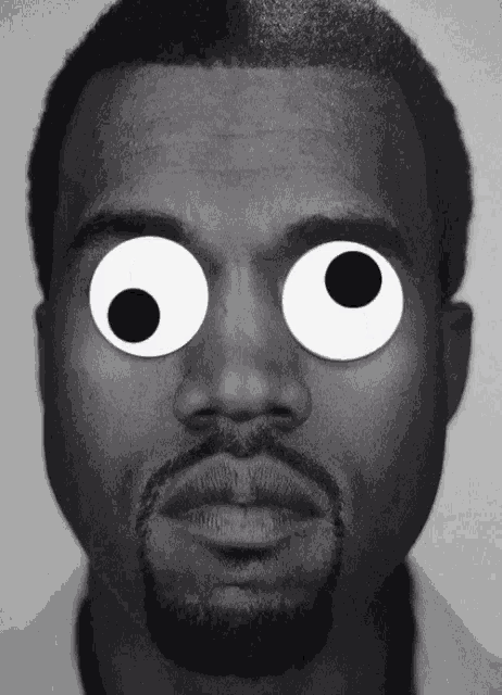 a close up of a man 's face with googly eyes on it