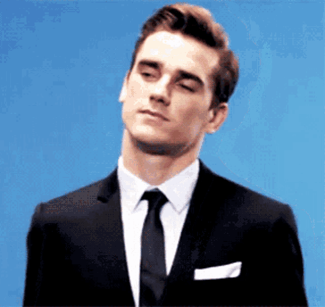 a man in a suit and tie is looking down