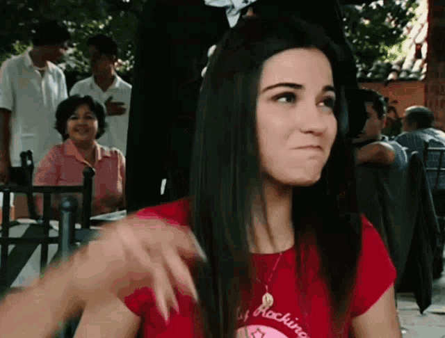 a woman wearing a red shirt that says rockino on it