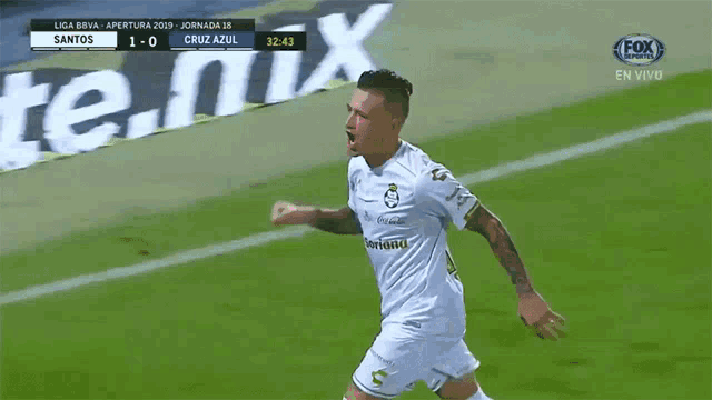 a soccer player celebrates a goal in front of a fox sports advertisement