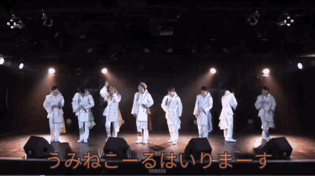 a group of people on a stage with yamaha written on the bottom right