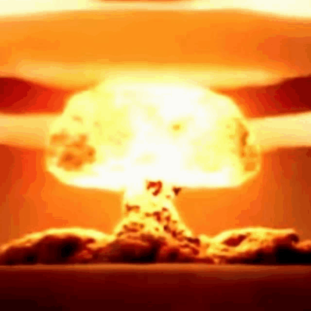 a close up of a nuclear explosion with a mushroom cloud coming out of the ground .