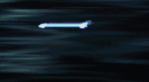 a purple and white light is coming out of a black background