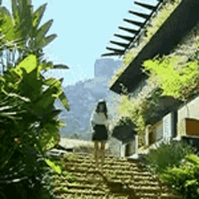 a woman is walking down a set of stairs in a garden .