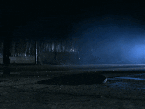 a person is coming out of a hole in the ground