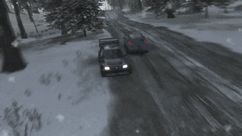 two cars are racing down a snowy road
