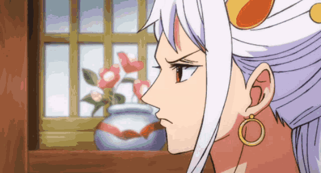 a woman with white hair and earrings is looking out a window .