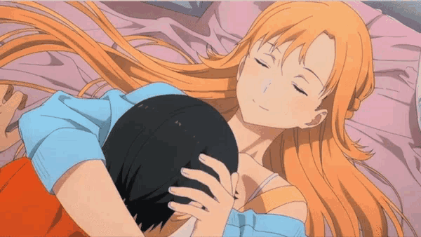 a girl with long orange hair is hugging a man