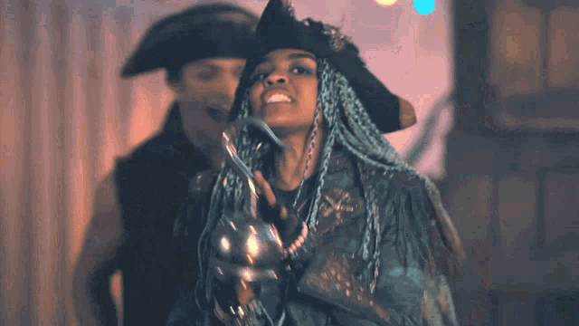 a woman with blue braids is holding a sword