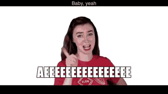 a woman in a red shirt is giving a thumbs up and says baby yeah .