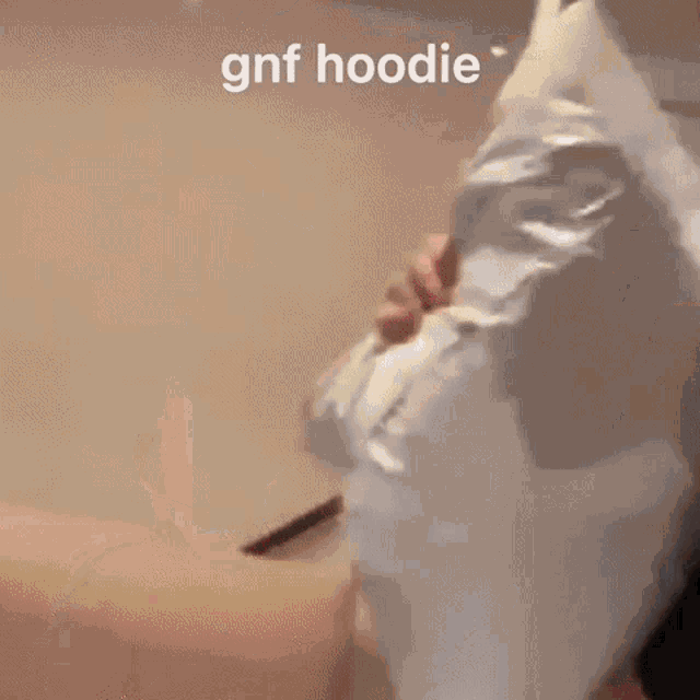 a close up of a man 's face with the words `` gnf hoodie '' written on it .
