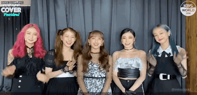 a group of girls are posing for a picture in front of a curtain that says kbs world cover festival