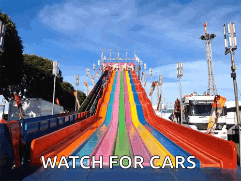 a colorful slide with the words " watch for cars " below it