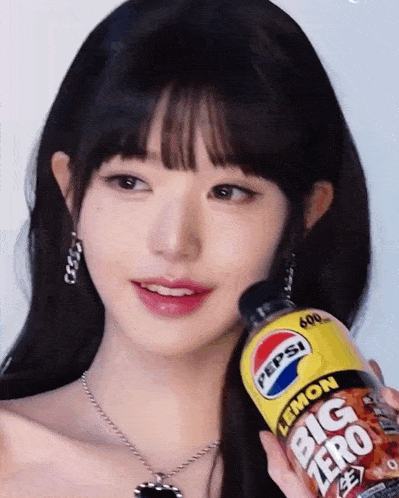 a woman holds a bottle of pepsi lemon big zero