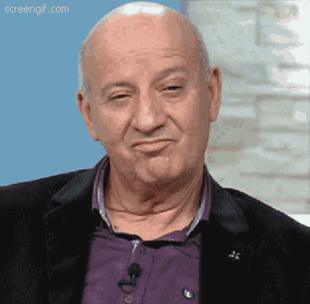 a bald man in a purple shirt and black jacket is making a funny face with screengif.com in the corner