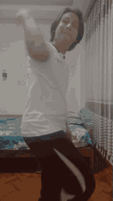 a person wearing glasses and a white shirt is dancing