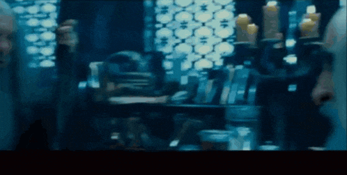 a blurry picture of a person standing in front of a shelf with candles