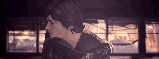a couple of people are hugging each other in a room .