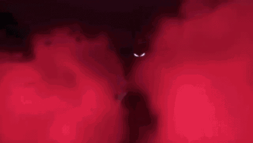 a close up of a cartoon character 's face with a pink smoke coming out of it 's mouth .