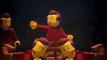 a group of lego figures in red shirts are laying on the ground
