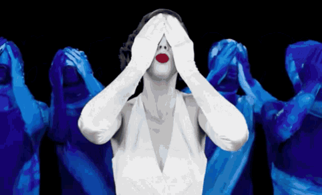 a woman with red lips and white gloves covers her face with her hands