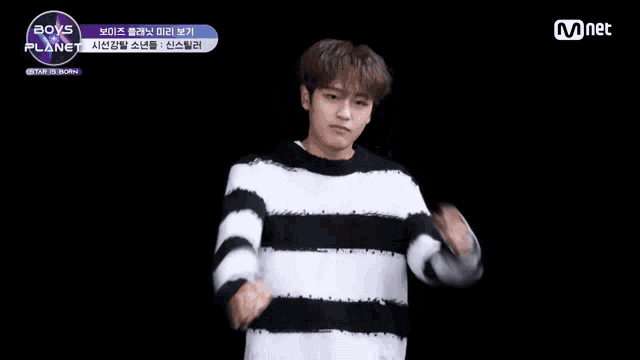 a man making a funny face with a mnet logo in the background