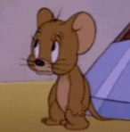 jerry from tom and jerry is sitting in front of a tent .