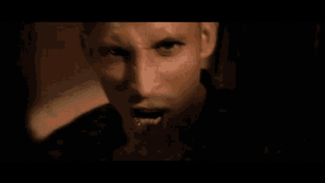 a close up of a person 's face with their mouth open