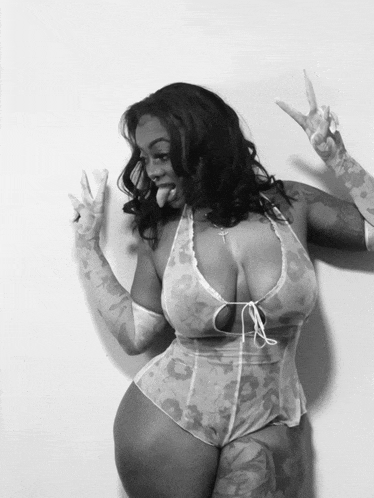 a black and white photo of a woman in lingerie