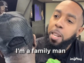 a man with a beard says i 'm a family man in front of another man 's head