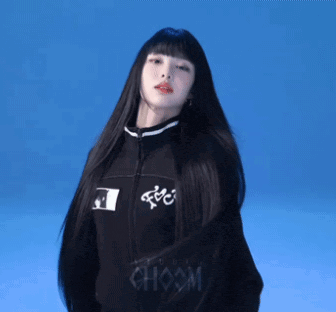 a woman with very long black hair is wearing a black choom jacket