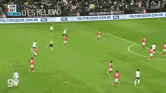 a group of soccer players on a field with advertisements for forteviron