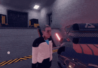 a man in a futuristic outfit stands in front of a machine with the letter a on the side