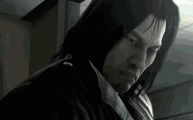 a man with long black hair and a white shirt has a serious look on his face