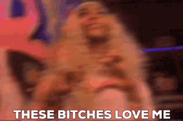 a blurry picture of a person with the words these bitches love me