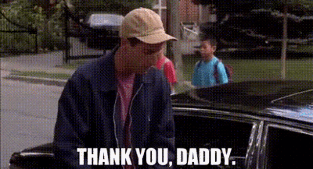 a man in a baseball cap is standing next to a car and saying `` thank you , daddy . ''