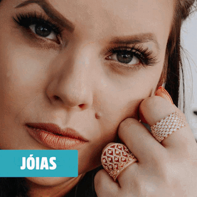 a close up of a woman 's face with the word joias in white