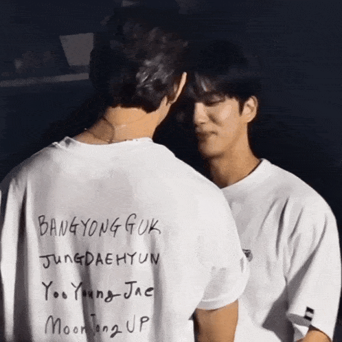 two men are standing next to each other with bangyong guk written on their backs