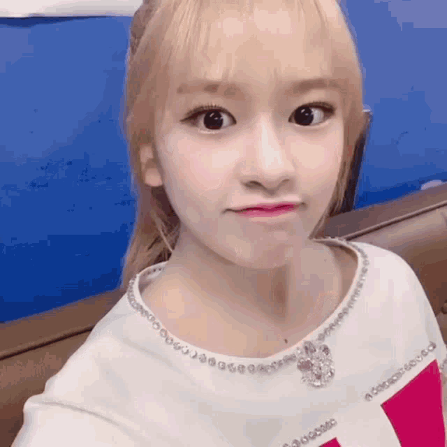 a girl taking a selfie with a necklace that says swarovski on it