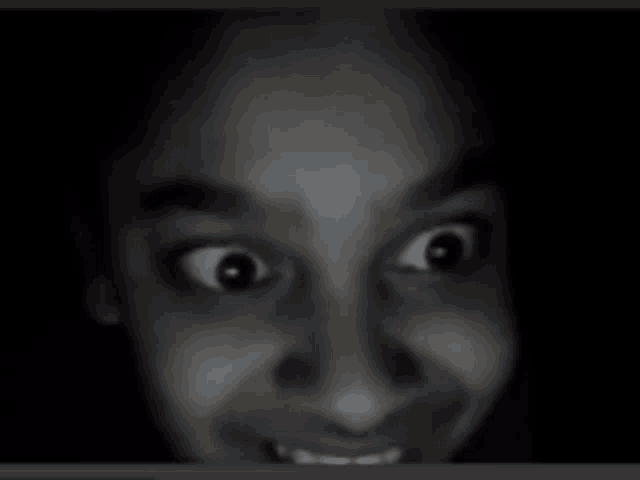 a close up of a person 's face with a slight smile on their face