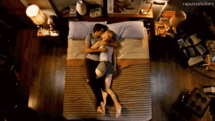 a man and a woman are laying on a bed with the words rapunzelsdiary written on the bottom