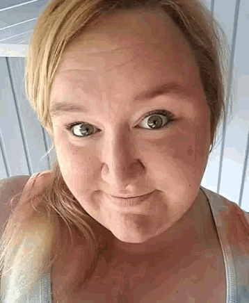 a woman with blonde hair is making a funny face with her eyes closed .