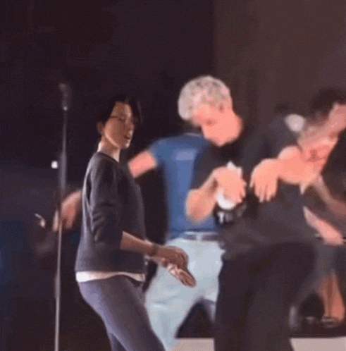 a man and a woman are dancing together in a blurry photo .