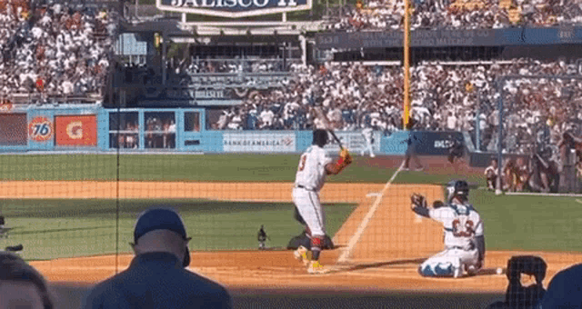 a baseball game is being played in a stadium with a sign that says 76