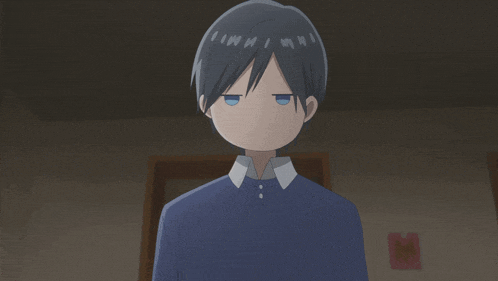 a boy with blue eyes and a blue shirt is looking at the camera